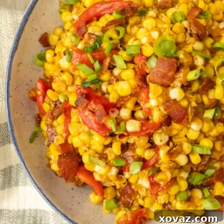 fried sweet corn with bacon, green onions and roasted red peppers in a bowl