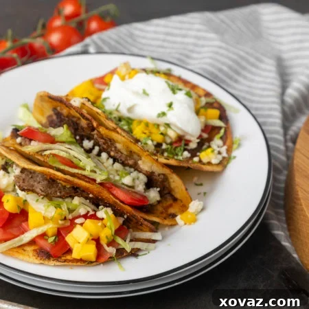 Crispy Smash Tacos 8 smash tacos on stacked plates with toppings in bowls