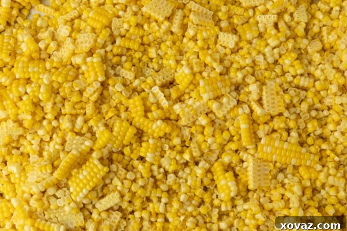 Preserving Sweet Corn for Winter 2 Sweet corn kernels neatly cut from the cob, piled on a cutting board, ready for freezing
