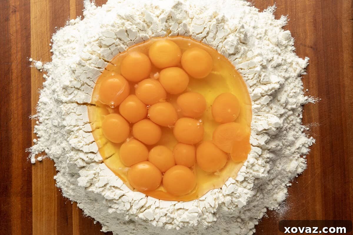 Mastering Fresh Pasta from Scratch 4 Flour mound with a well for eggs, traditional pasta making method.