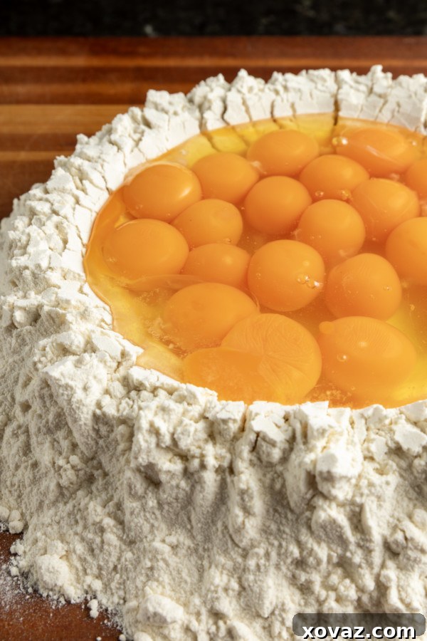 Mastering Fresh Pasta from Scratch 7 Hands kneading pasta dough on a wooden surface.