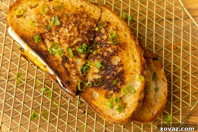 Close-up of the gooey, melted cheese and stir-fried kimchi filling inside the sandwich.
