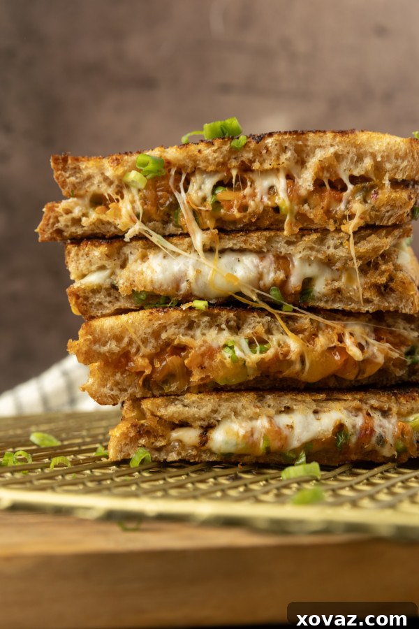 Stack of kimchi grilled cheese with a side of crispy potato chips.