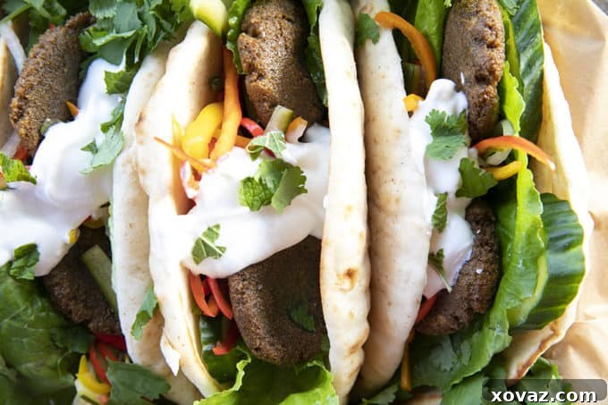 Falafel in flat bread with yogurt, pickled vegetables, lettuce, and cilantro.