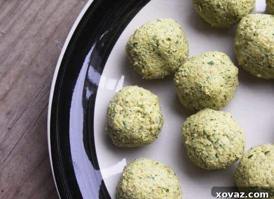 Falafel balls before frying on a black and white plate