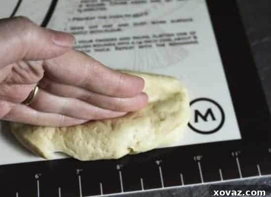 The dough oval with a deep indentation pressed down its center, creating a ridge.