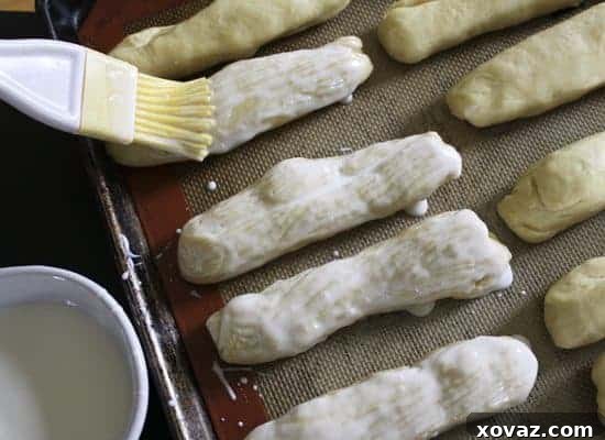 Puffy hot dog buns brushed generously with buttermilk before baking for a golden crust.