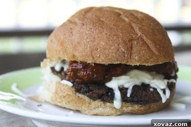 Delicious pizza black bean burger on a bun with melted mozzarella and fresh basil