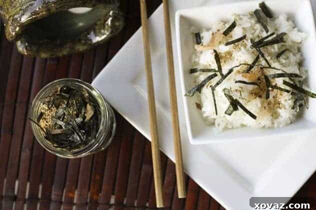 Delicious Furikake seasoning sprinkled over a bowl of white rice, highlighting its texture.