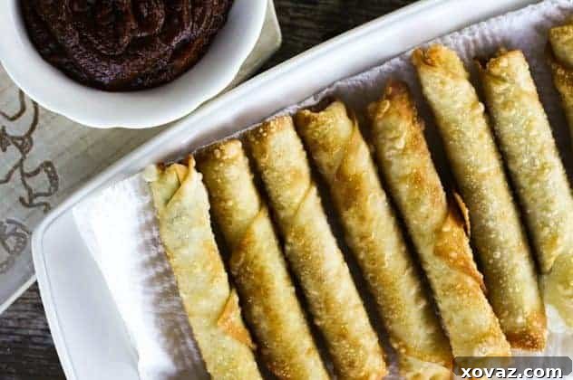 Golden-brown, crispy fried mozzarella sticks with a gooey cheese pull, served with a side of rich pizza sauce.