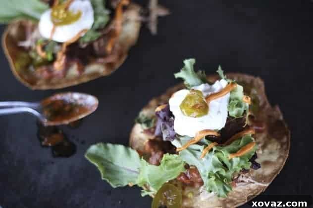 Two Carnitas Style Chicken Tostadas garnished with fresh cilantro