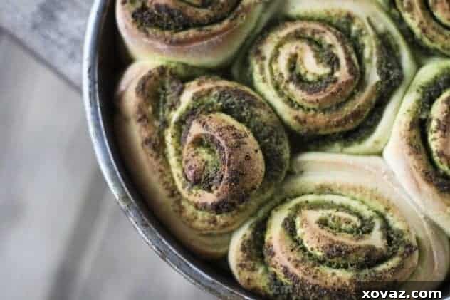 Pesto Pinwheel Rolls baked in a round cake pan, showing soft, connected layers.