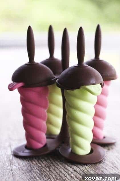 Three creamy lemon lime popsicles on a wooden surface