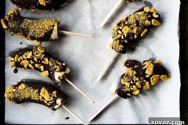 Chocolate Covered Banana Pops: A Summer Delight Freshly made Chocolate Covered Banana Pops on a stick, coated in rich dark chocolate and some with colorful sprinkles, beautifully arranged for a refreshing summer treat.