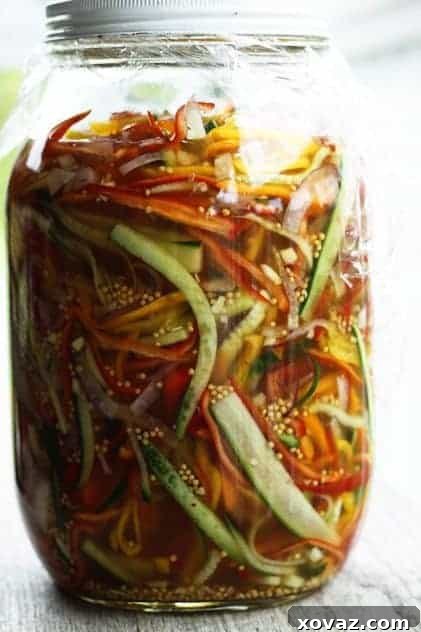Gallon Jar Refrigerator Pickles Large gallon jar filled with vibrant Refrigerator Pickled Salad, ready for marinating