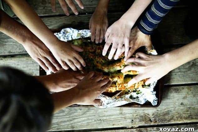 The Crowd-Pleasing Power of Cheesy Bread Kids enthusiastically grabbing slices of Cheddar Tailgating Bread