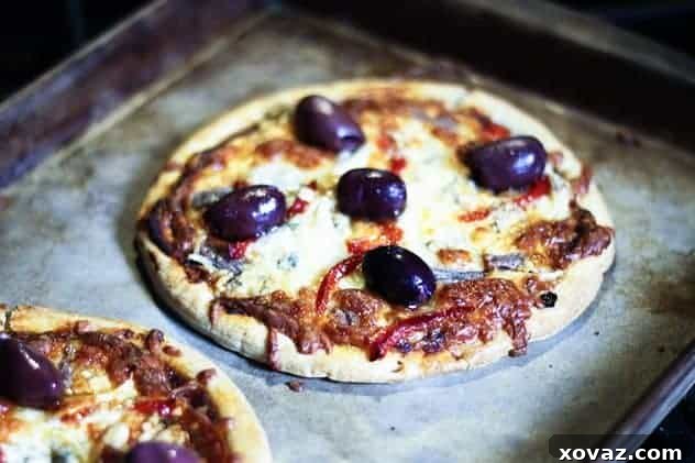 Roasted Red Peppers in Garlic Olive Oil Uses Slices of roasted red bell peppers in a jar, glistening with olive oil and garlic, ready for culinary use.