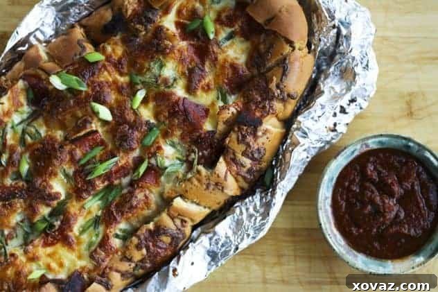 Pizza Party Bread Ooey, gooey Pizza Party Bread with melted mozzarella and crispy pepperoni, ready to be torn and shared.