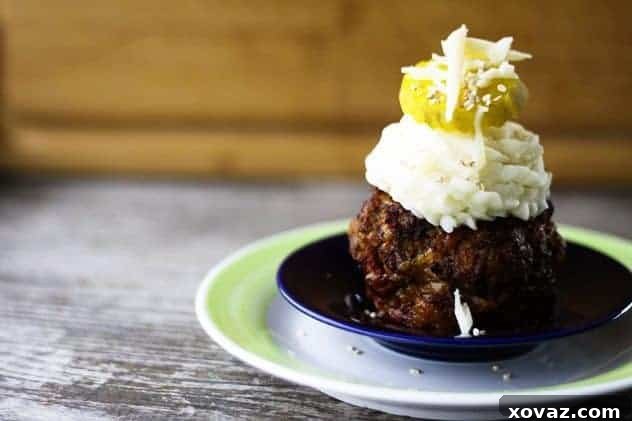 Bacon Cheeseburger Meatloaf with Cheesy Mashed Potatoes Bacon Cheeseburger Meatloaf with Cheesy Mashed Potatoes, beautifully presented with piped mashed potato topping, garnished with bacon bits and chives.