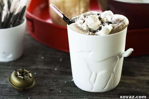 Rich Peppermint Mocha in a beautiful fawn mug, topped with whipped cream and crushed candy canes.