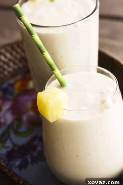 Tropical Vegan Piña Colada Bliss 2 Piña Colada Smoothies, a delicious blend of pineapple, coconut, and banana.