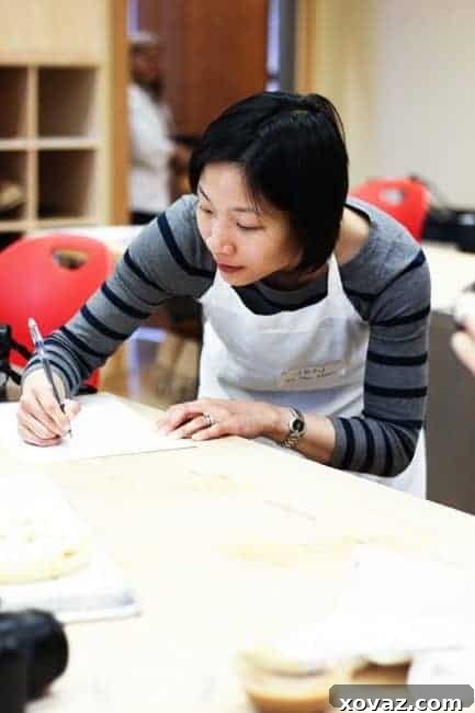 King Arthur Flour: Baking & Beyond 20 Jennifer Che of Tiny Urban Kitchen focused during a baking class