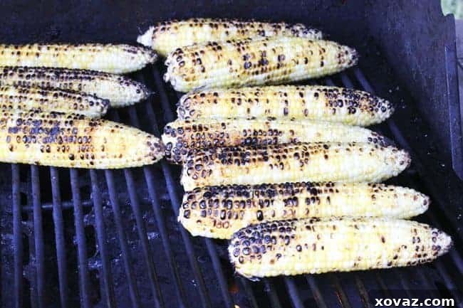 Grilling corn on high heat, turning frequently for even charring and delicious flavor.