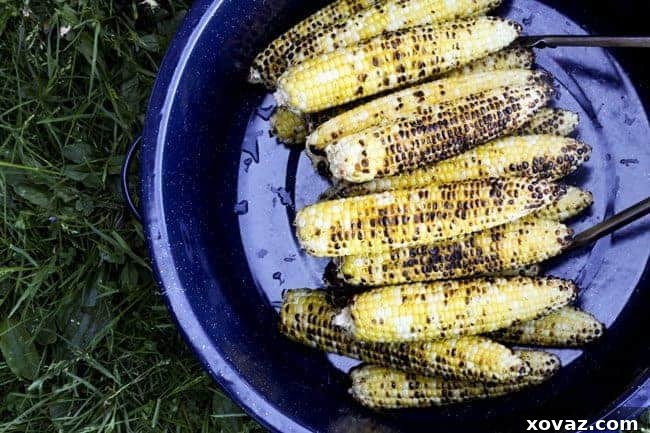 Cooled grilled corn cobs ready for the kernels to be cut off for the Mexican Street Corn Salad.