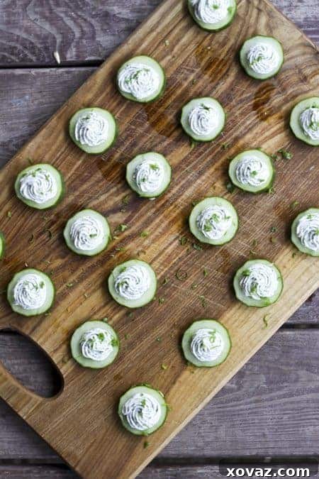 Fresh Cucumber Herbed Cream Cheese Bites 3 Close-up of herbed cream cheese cucumber bites on a platter, ready to be served as a quick and healthy appetizer.