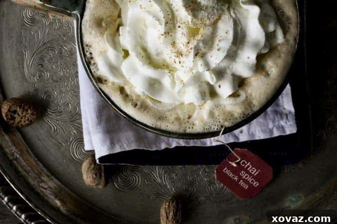 Pumpkin Spice Chai Latte topped with whipped cream and grated nutmeg
