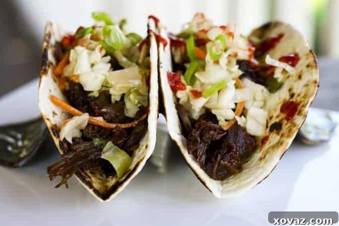 Set and Forget Korean Beef Tacos for Effortless Meal Prep 5 Slow Cooker Korean Beef Tacos garnished with slaw and cilantro for Make Ahead Mondays