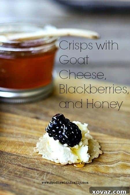 Crisps with creamy goat cheese, ripe blackberries, and a drizzle of golden honey, elegantly arranged on a serving board.