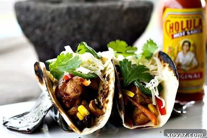 Delicious Slow Cooker Barbecue Chicken Tacos served with fresh toppings