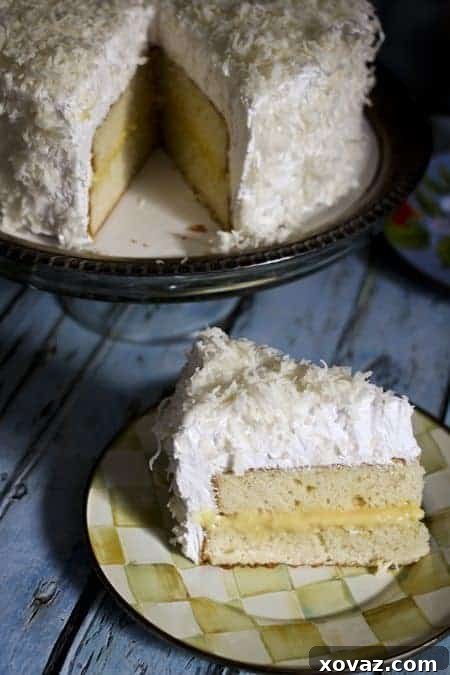 Zesty Coconut Cloud Cake 2 Delicious Coconut Lemon Cake slices on a plate with vibrant lemon curd