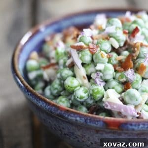Easy Bacon Pea Salad: It doesn't get much easier or tastier than this cold salad of peas, crispy bacon, crunchy red onions, and creamy dressing. Serve with grilled or roasted chicken, pork, fish, or even ham!