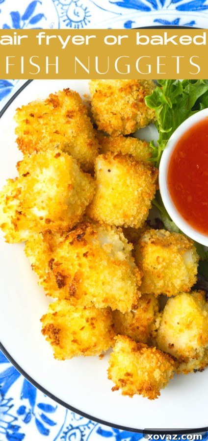 A hand dipping a perfectly golden and crispy Ranch fish nugget into a creamy white sauce, emphasizing its delicious appeal.