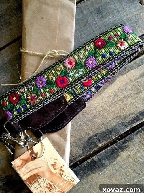 Close-up of Nena & Co. hand-loomed camera strap, showcasing intricate patterns and real leather details. A unique accessory for photographers.