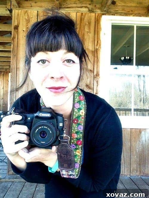 Stylish woman wearing a Nena & Co. hand-loomed camera strap with genuine leather, demonstrating comfort and fashion. Perfect for photographers.
