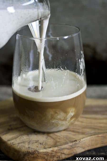 Homemade Snickerdoodle Coffee Creamer in a jar with cinnamon sticks, ready to be added to your favorite beverage. foodiewithfamily.com