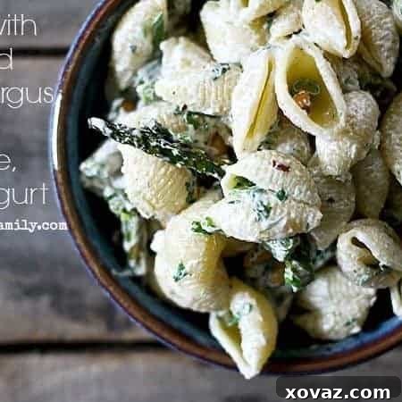 Shells with Roasted Asparagus, Goat Cheese, and Yogurt with chile oil toasted pinenuts to garnish. Light and healthy and fast! foodiewithfamily.com