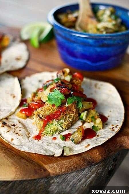 Golden Fried Avocado Tacos with Smoky Pineapple Relish 3 Close-up of Crispy Avocado Tacos with Grilled Pineapple Relish, highlighting the vibrant colors and textures.