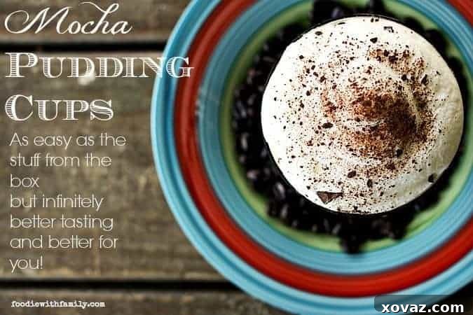 Close-up of three Mocha Pudding Cups, garnished with whipped cream and chocolate shavings, on a wooden board.