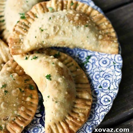 Shepherd's Pie Empanadas with beef, gravy, corn, peas, and mashed potato stuffed in a flaky, golden brown crust.