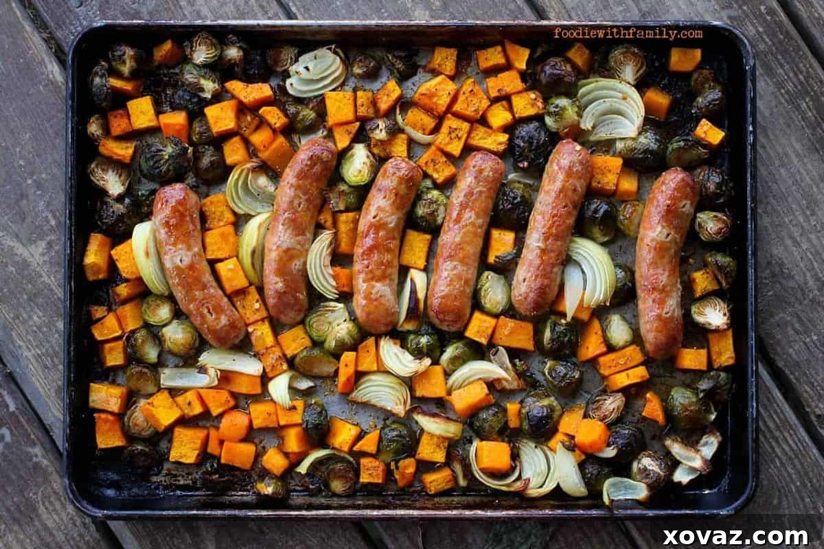 A vibrant sheet pan overflowing with perfectly roasted butternut squash, Brussels sprouts, onions, and sweet Italian sausage links, golden-brown and ready to serve. Ideal for a cozy fall dinner. from foodiewithfamily.com