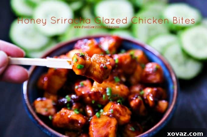 Close-up shot of Honey Sriracha Glazed Chicken Bites, highlighting the sticky glaze and fresh chives