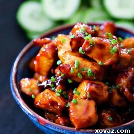 Overhead shot of Honey Sriracha Glazed Chicken Bites in a modern serving dish