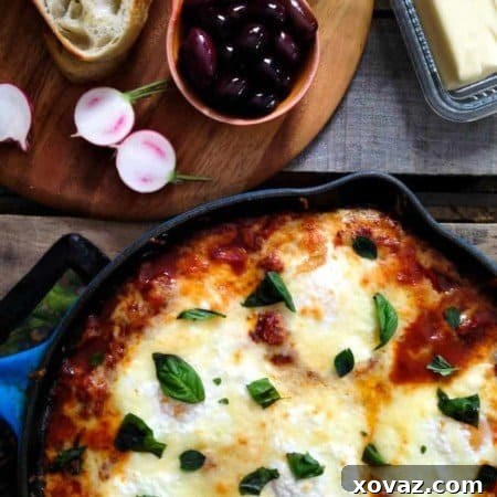 Portuguese Style Baked Eggs. Spicy tomato and red pepper sauce, three cheeses, fresh herbs from foodiewithfamily.com