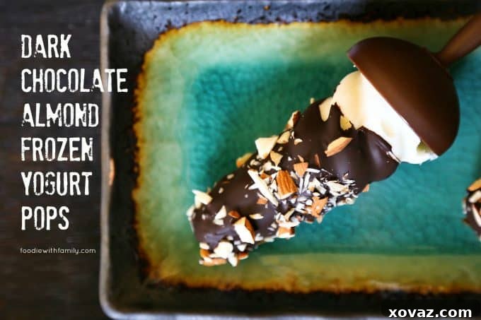 Delicious Dark Chocolate Almond Frozen Yogurt Pops coated in chocolate and sprinkled with almonds, ready to be enjoyed as a cool summer treat.