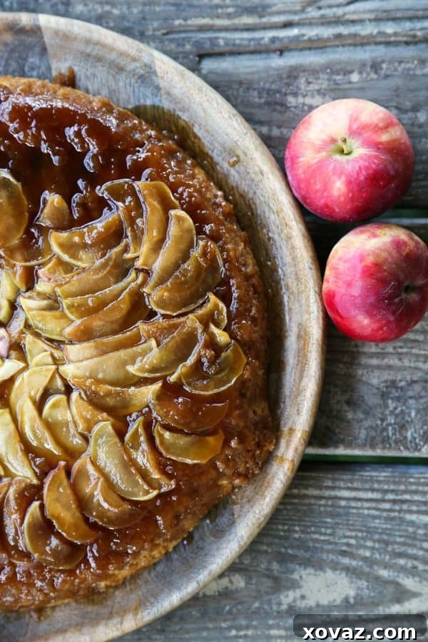 Delicious Vegan Maple Apple Upside Down Cake baked in a cast iron skillet, perfect for fall desserts.