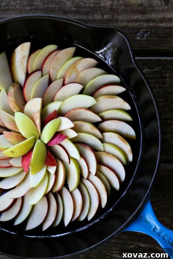 Freshly baked Maple Apple Upside Down Cake cooling in a cast iron skillet.